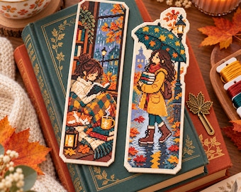 May include: Two rectangular cross-stitch bookmarks featuring autumn scenes. One depicts a person reading by a window with a cat and a mug. The other shows a person walking in the rain under a patterned umbrella while holding a stack of books.
