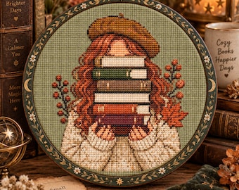 May include: A circular cross-stitch embroidery piece featuring a person with long wavy red hair wearing a mustard yellow beret and a cream-colored sweater. The person holds a stack of five books in front of their face. The background is sage green.
