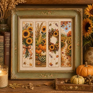 May include: A framed cross-stitch embroidery featuring four vertical panels depicting autumn themes: a sunflower bouquet with a plaid bow, pumpkins with wheat, a sunflower wreath, and a path through a sunflower field with falling leaves.