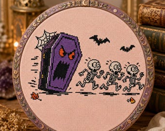 May include: A circular embroidery hoop containing a cross-stitch design on light pink fabric. The design features a purple coffin with a face chasing three white skeletons. Two black bats, a spider web, a small orange leaf, and candy are included.