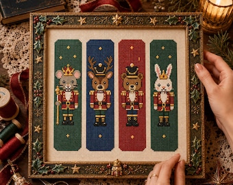 May include: A framed cross-stitch embroidery featuring four vertical panels with anthropomorphic nutcracker characters: a mouse, a deer, a bear, and a rabbit, each wearing a uniform and crown, set against green, blue, and red backgrounds.