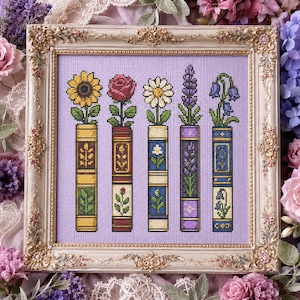 May include: A cross-stitch embroidery featuring five vertical books on a light purple background, each topped with a different flower: a sunflower, a red rose, a daisy, a sprig of lavender, and blue bellflowers, all encased in an ornate gold frame.