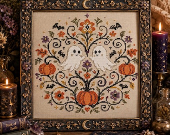 May include: A square cross-stitch embroidery featuring two white ghosts, three orange pumpkins, and black bats surrounded by floral motifs on beige fabric. The piece is encased in a dark, ornate frame decorated with gold stars and crescent moons.