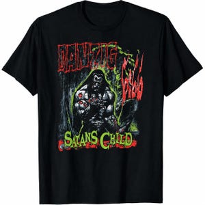 May include: A black short-sleeve t-shirt featuring a graphic print of a muscular figure with long dark hair. The text Danzig is printed in red at the top, with Satans Child in green at the bottom, and additional red text on the right side.