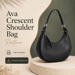 May include: A black crescent-shaped shoulder bag with a single strap attached by silver-toned metal rings. The text reads Ava Crescent Shoulder Bag Pattern, PDF Pattern, and Instant Download. The bag has a smooth, solid black exterior finish.