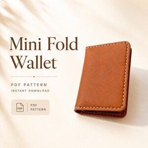 May include: A tan leather mini fold wallet with visible white stitching along the edges. The text reads Mini Fold Wallet, PDF PATTERN, INSTANT DOWNLOAD, and PDF PATTERN. The wallet is shown in a closed position with a smooth, matte finish.