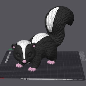 May include: A 3D digital model of a skunk with black fur, a white stripe running from its head down its back, and a large, bushy, textured tail. The skunk has pink accents on its nose, inner ears, and paws, and is positioned on a grid platform.