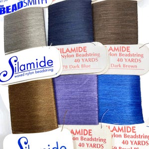 May include: Assortment of spools of waxed nylon beadstring in various colors, including ash grey, dark blue, dark brown, lilac, and royal blue. The labels read "Silamide" and "The BeadSmith". Each spool contains 40 yards of string.