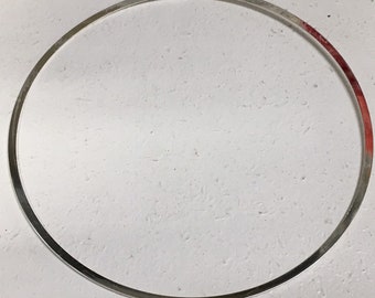 May include: A silver metal ring with a smooth, polished finish. The ring is circular and appears to be made of a single piece of metal.