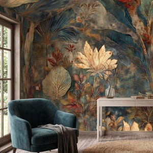 May include: A wall mural featuring a dark teal and gold botanical pattern with large tropical leaves and flowers. The design includes intricate gold line work on a textured, moody background. A teal armchair, a light wood console table, and a floor lamp.