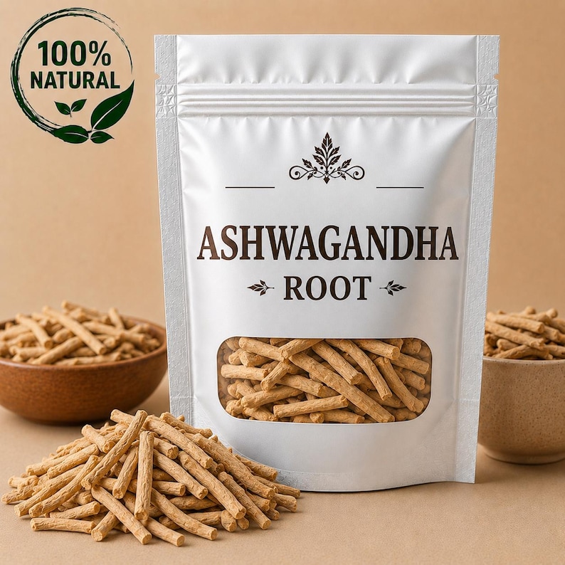 May include: A white stand-up pouch containing light brown ashwagandha root pieces, featuring a clear window and text reading ASHWAGANDHA ROOT. A circular logo in the top left corner displays the text 100% NATURAL with a leaf graphic icon.