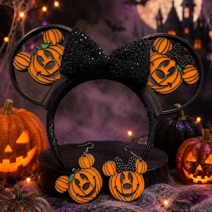 May include: A black headband featuring two circular ears with orange pumpkin designs shaped like mouse heads, topped with a large black glittery bow, accompanied by a pair of matching dangling earrings with orange pumpkin mouse head charms.