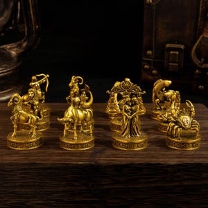 May include: A collection of gold-colored metal zodiac figurines standing on circular bases. The set includes representations of Aries, Taurus, Gemini, Cancer, and other astrological signs, each featuring intricate details and symbolic imagery.