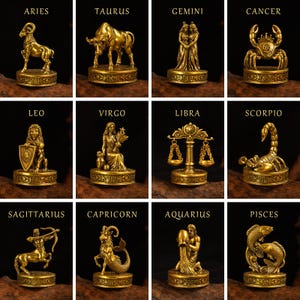 May include: A collection of twelve gold-colored zodiac figurines, each mounted on a circular base with intricate relief patterns. The set includes Aries, Taurus, Gemini, Cancer, Leo, Virgo, Libra, Scorpio, Sagittarius, Capricorn, Aquarius, and Pisces.