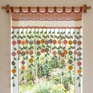May include: A crochet window valance featuring a top section with a grid pattern in rust and cream yarn. Hanging from the valance are multiple vertical strands of green vines adorned with small, colorful crocheted flowers in yellow, pink, and blue.