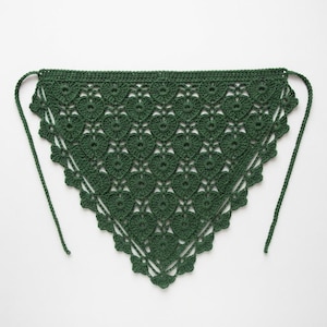 May include: A dark forest green triangular crochet bandana featuring a repeating heart motif pattern throughout the body. The edges are finished with a delicate scalloped border and two long crocheted ties extending from the top corners.