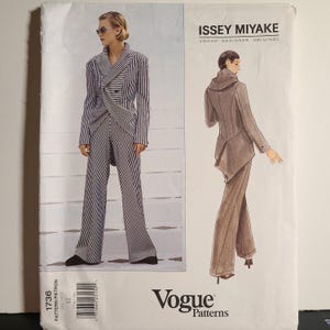 May include: A Vogue Patterns sewing pattern envelope for an Issey Miyake designer original, number 1736, size 12. The front shows a black and white striped suit with a wrap jacket and wide-leg trousers, alongside a brown suit illustration.