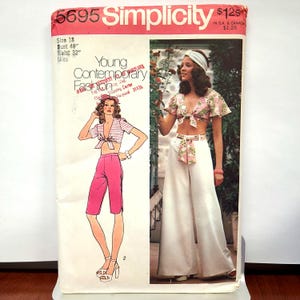 Può includere: Una busta per cartamodello Simplicity, numero 5695, con un design Young Contemporary Fashion. La copertina mostra illustrazioni e una fotografia di un top corto con allacciatura frontale abbinato a pantaloni capri rosa o pantaloni bianchi a gamba larga.