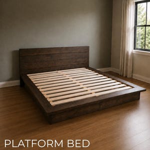 May include: A dark brown wooden platform bed frame with a horizontal plank headboard and light-colored wooden slats. The bed frame is low to the ground and features a wide border around the mattress area. The text PLATFORM BED is visible.