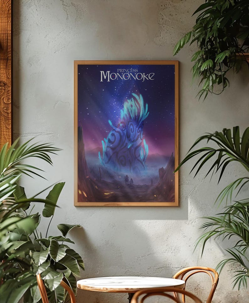 May include: A rectangular framed wall art print featuring the title Princess Mononoke in white text at the top. The artwork depicts a glowing blue forest spirit creature with intricate dark patterns against a starry night sky and misty landscape.