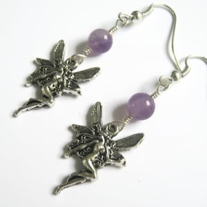 May include: Silver earrings with a fairy charm and a lavender amethyst bead.