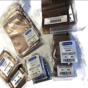 May include: Several clear plastic bags containing small, metallic-colored pouches. Each bag has a white label with black text, including the words "INTERCEPT ANTI-TARN BAGS" and the number "10 EA". The bags are from Rio Grande.