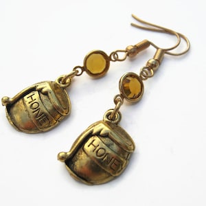 May include: Gold tone earrings with honey pot charms and amber colored glass beads.