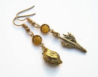 May include: A pair of gold earrings with amber-colored glass beads and a wheat sheaf charm on one earring and a gold acorn charm on the other.