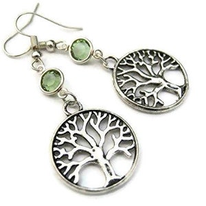 May include: Silver earrings with a tree of life design and green gemstone accents.
