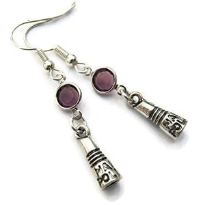 May include: A pair of silver earrings with purple glass beads and a charm that says "May the Force be with you".