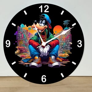 May include: A round wall clock with a black face and white numerals. The center features a colorful illustration of a cartoon dog wearing a blue cap, green jacket, red sleeves, and gold chains, sitting in a brick alleyway with graffiti.