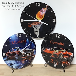 May include: Three circular wall clocks made of laser-cut acrylic with UV printing. The top clock features a flaming basketball and hoop. The bottom left clock displays a classic Mustang car, and the bottom right clock shows a Corvette sports car.