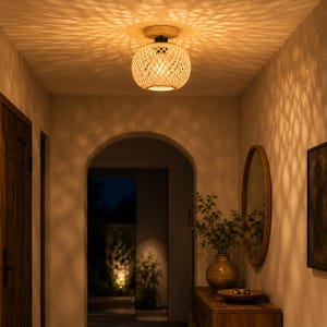 May include: A spherical flush mount ceiling light fixture featuring a woven light brown bamboo shade. The fixture is attached to a circular wooden base and emits a warm glow that casts intricate, repeating geometric shadow patterns.