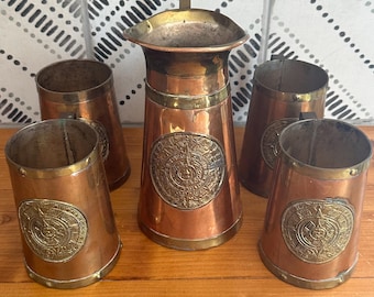 Juego de jarra y taza con calendario azteca en tono cobre vintage, arte popular mexicano, decoración de bar del suroeste