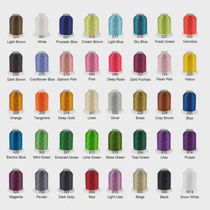 May include: A color chart featuring forty spools of embroidery thread arranged in five rows of eight. Each spool is labeled with a unique numerical code and a corresponding color name, including shades like Light Brown, White, and Snow White.