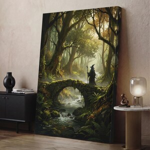 May include: A rectangular canvas wall art print depicting a hooded figure in a dark robe holding a staff, standing on a stone bridge over a flowing stream in a dense, mossy forest with tall trees and soft, golden light filtering through the canopy.