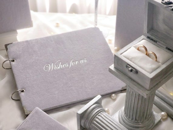 A genuinely handcrafted velvet guest book that doubles as a keepsake heirloom — the kind of wedding object that sits on a shelf for decades.