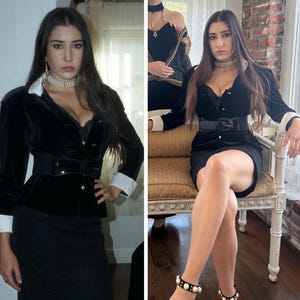 May include: A black velvet blazer with white cuffs and a black belt. The blazer is paired with a black skirt or dress. The outfit is accessorized with a pearl choker and bracelet. The overall style is elegant and classic.