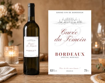 Peut inclure: Une bouteille de vin en verre foncé avec une étiquette blanche présentant un dessin de château, le texte "Cuvée du Témoin", "BORDEAUX SPÉCIAL MARIAGE", "Veux-tu être mon témoin ?", "12% vol." et "75 cl". L'étiquette porte aussi "GRAND VIN DE BORDEAUX".