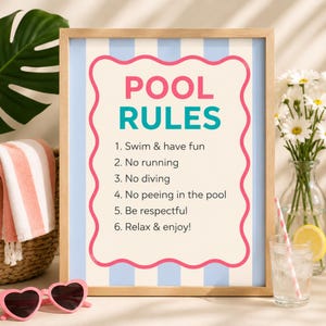 May include: A framed sign with a light blue and white striped background featuring the text POOL RULES in pink and teal, followed by a numbered list of six rules including Swim & have fun, No running, No diving, No peeing in the pool, Be respectful, and Relax & enjoy.