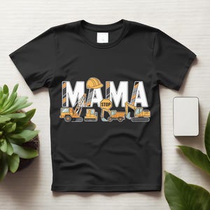 May include: A black short-sleeved t-shirt featuring the white text MAMA with a yellow construction helmet on the first A. Below the text are illustrations of yellow construction vehicles including a crane, a bulldozer, and an excavator.