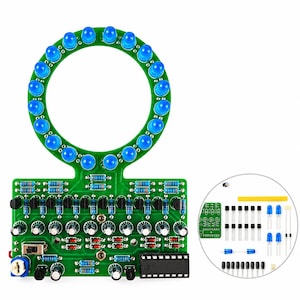 May include: A green circular printed circuit board featuring twenty-four blue LED lights arranged in a ring, connected to a rectangular base with various electronic components including resistors, capacitors, transistors, and an integrated circuit chip.