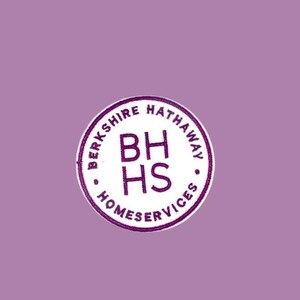 May include: A circular logo with the text "BERKSHIRE HATHAWAY HOMESERVICES" in a ring around the edge. Inside the ring are the letters "BH HS" in a stacked arrangement. The logo is in purple and white against a lavender background.