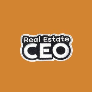 May include: A patch with the words "Real Estate CEO" in white, outlined in black, on a black background. The patch has a white border and is set against an orange background.