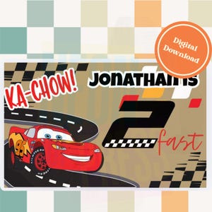 May include: A digital download featuring a red race car with the text "Ka-Chow!" and "Jonathan's 2 fast." The design includes a racetrack and a checkered flag, with an orange circle that says "Digital Download."