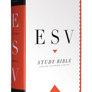 May include: A hardcover ESV Study Bible with a white cover and black text. The spine is red with white lettering. The title "ESV STUDY BIBLE" is displayed prominently. The book is a religious text.