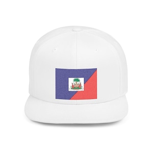 May include: A white baseball cap featuring a rectangular patch on the front panel. The patch displays the national flag of Haiti, which is divided into blue and red sections with the central coat of arms showing a palm tree and weapons.