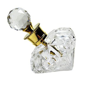 May include: A clear glass perfume bottle shaped like a diamond with a faceted surface. The bottle features a gold-colored metal neck and a spherical, faceted clear glass stopper that sits atop the opening, creating a reflective appearance.