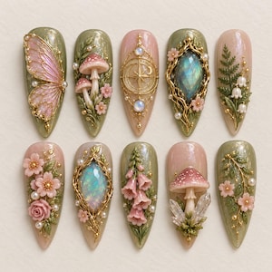 May include: A set of ten almond-shaped press-on nails featuring intricate 3D designs including pink butterfly wings, mushrooms, gold filigree, iridescent gemstones, fern leaves, lily of the valley, cherry blossoms, and crystal accents.
