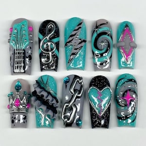 May include: A set of ten press-on nails featuring a color palette of teal, black, gray, and hot pink. Designs include a guitar, treble clef, lightning bolt, swirls, a crown, ruffles, a silver chain, a broken heart, and star accents with 3D elements.